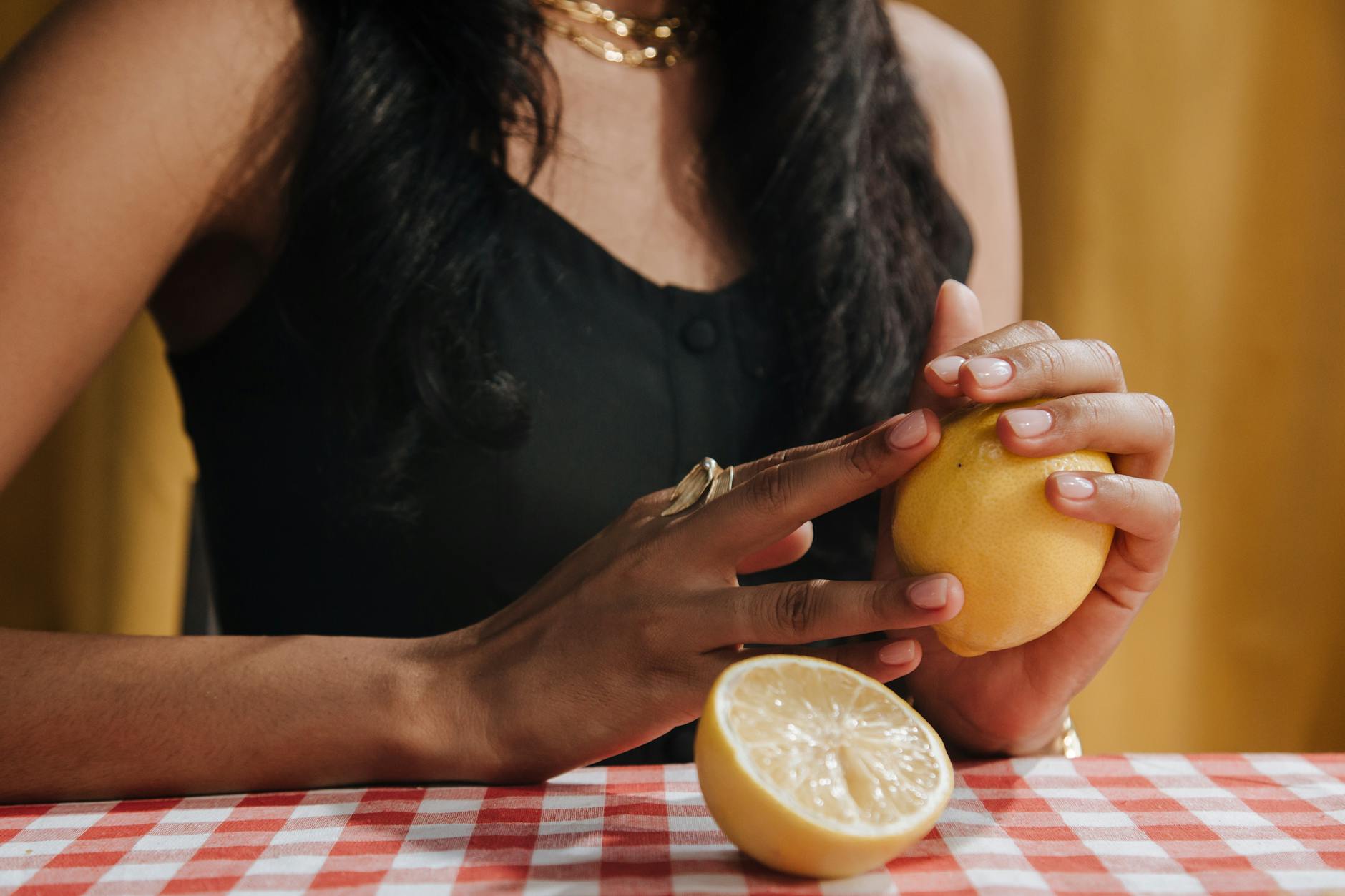 A woman holding a fresh lemon, symbolizing the quick fix to rushed intimacy